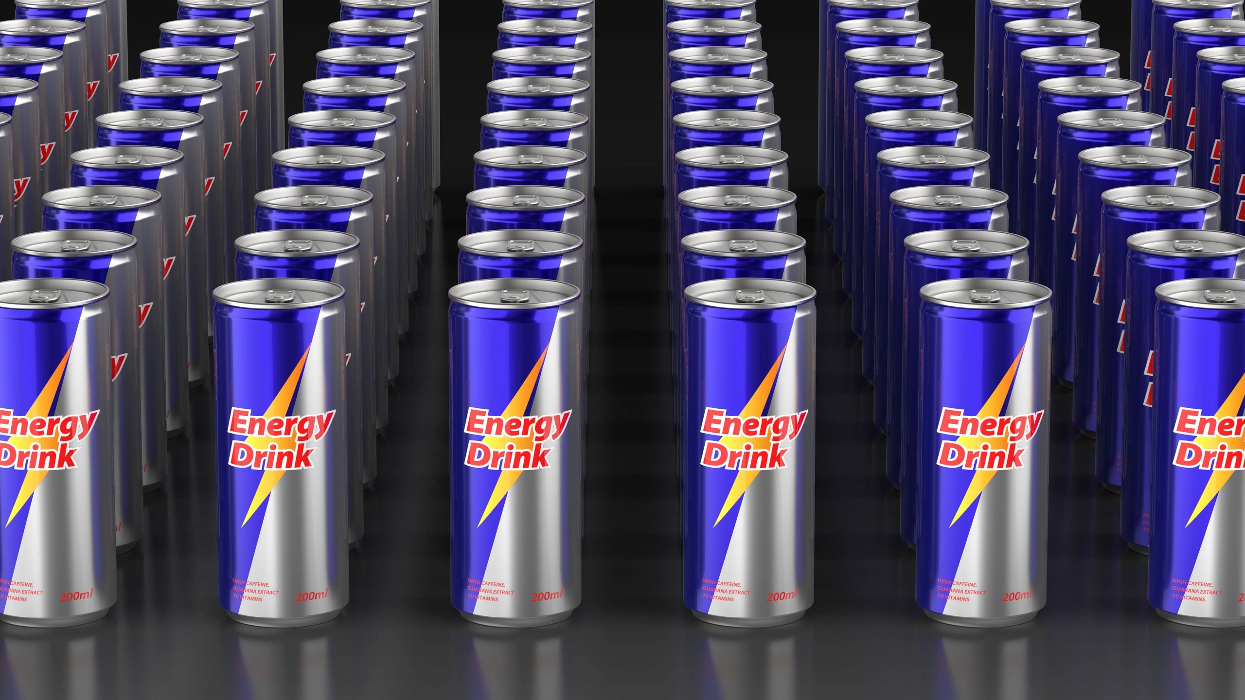 Multiple black energy drink cans on a dark background